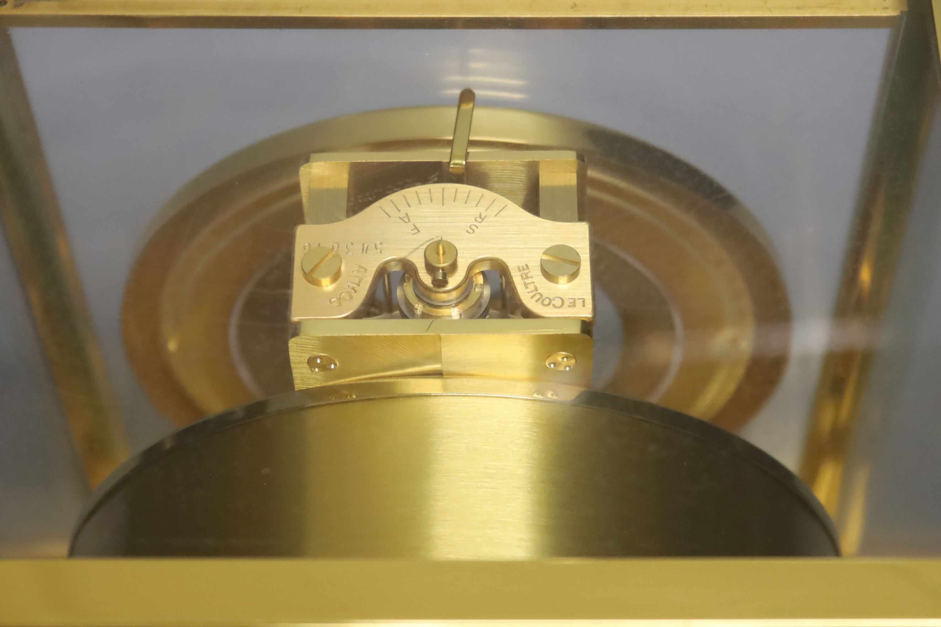 A Jaeger le Coultre Atmos mantel clock, with white enamelled Roman chapter ring, in gilt-brass panelled case, height 22.5cm